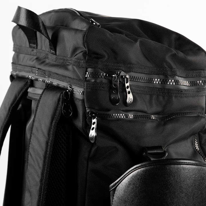 Close-up of the ONAX black backpack with zippers on a white background.