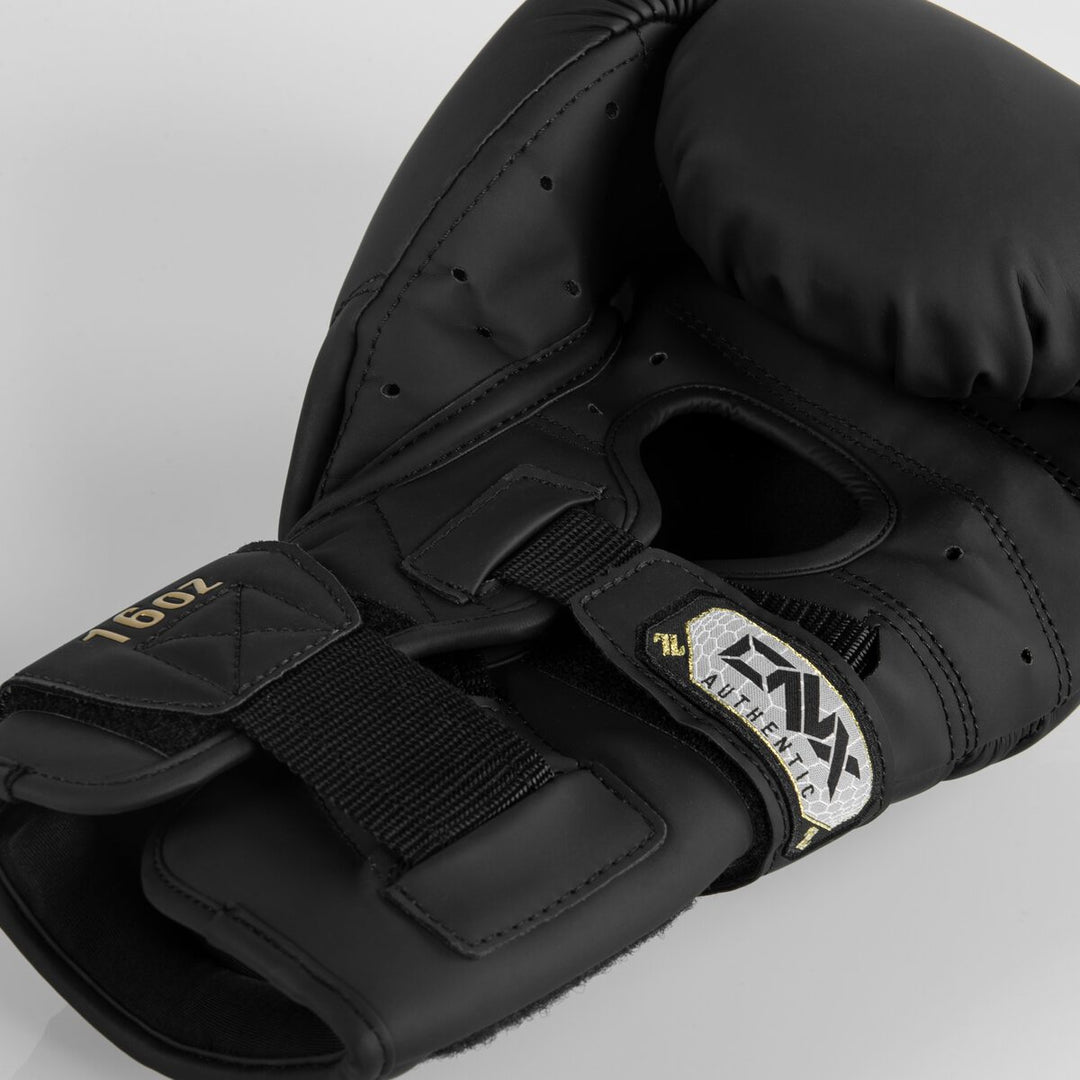 Close-up of the ONX X-Factor Glove interior hand opening and wrist strap with 16oz label