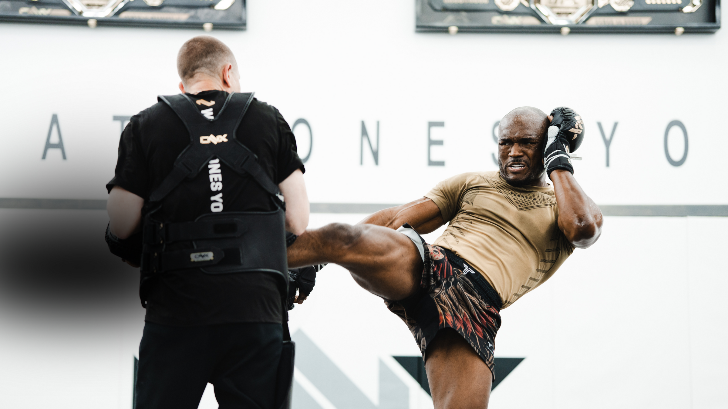 UFC Fighter Kamaru Usman  executing an MMA kick in training with Coach Trevor Wittman.