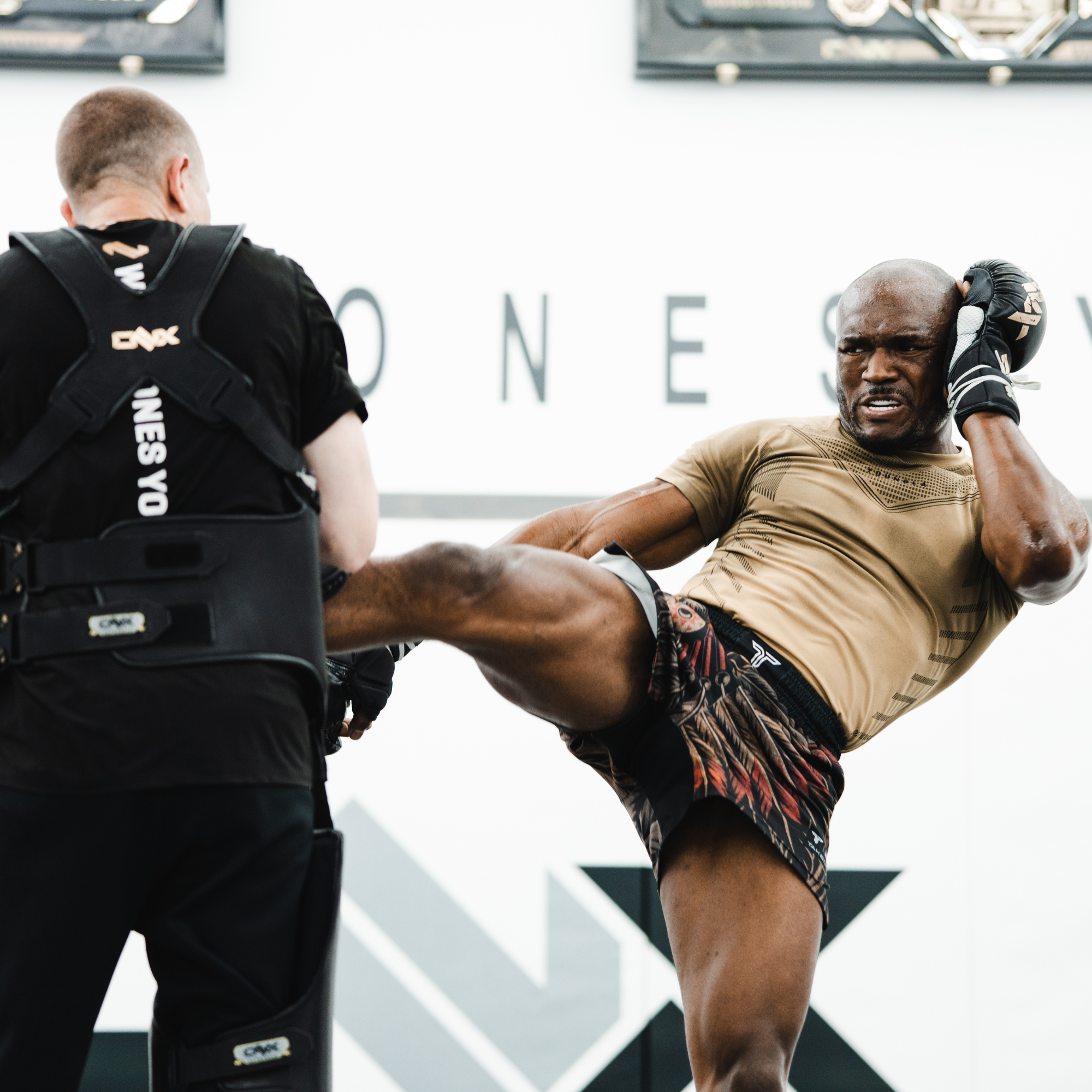 UFC Fighter Kamaru Usman  executing an MMA kick in training with Coach Trevor Wittman.
